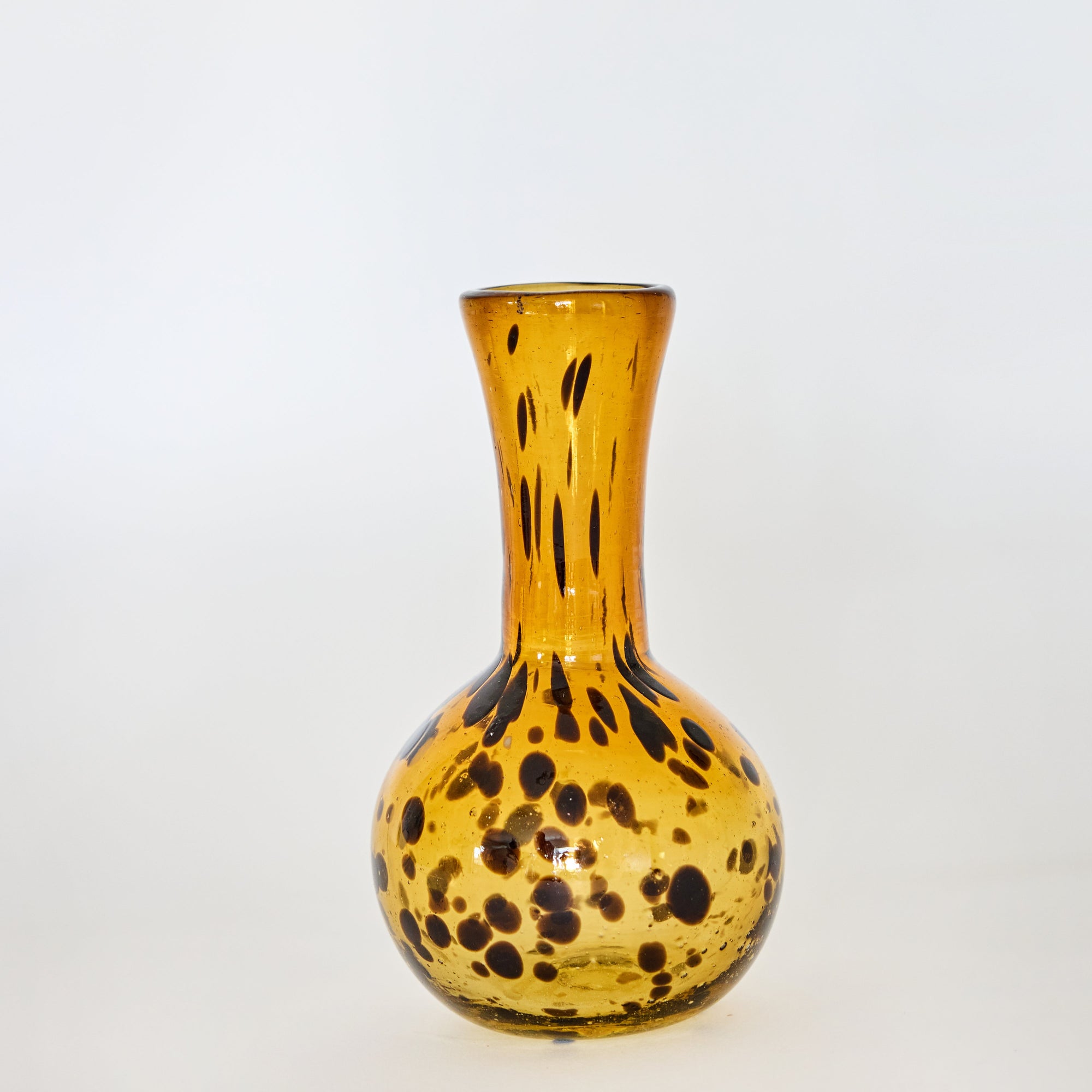 A hand-blown, brown glass vase with a tortoise shell pattern