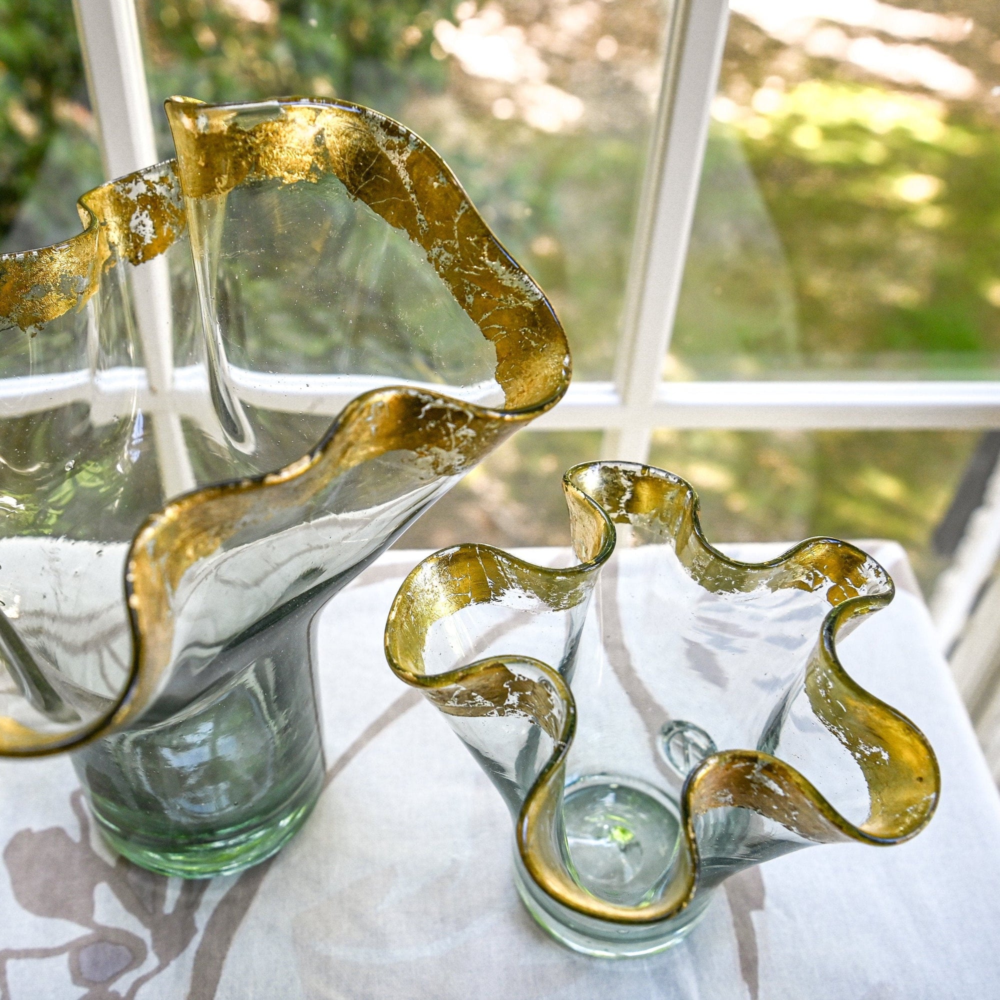 Two clear vases with 14k gold leaf ribbon rims on top view