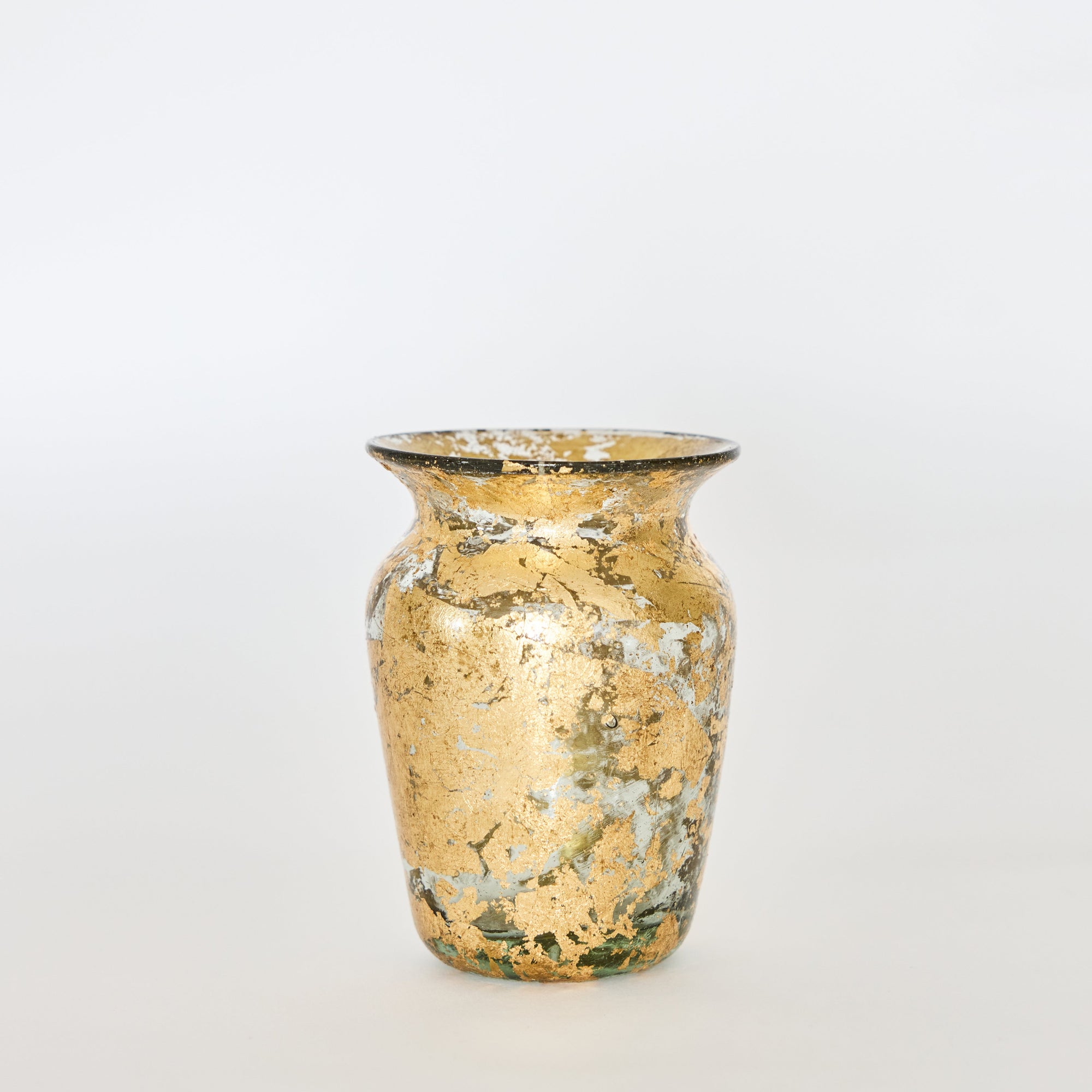 A hand-blown glass vase with 14k gold leaf detailing, featuring a tall, slender shape with a reflective surface.
