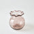 Pink glass vase with wavy rim on a white background