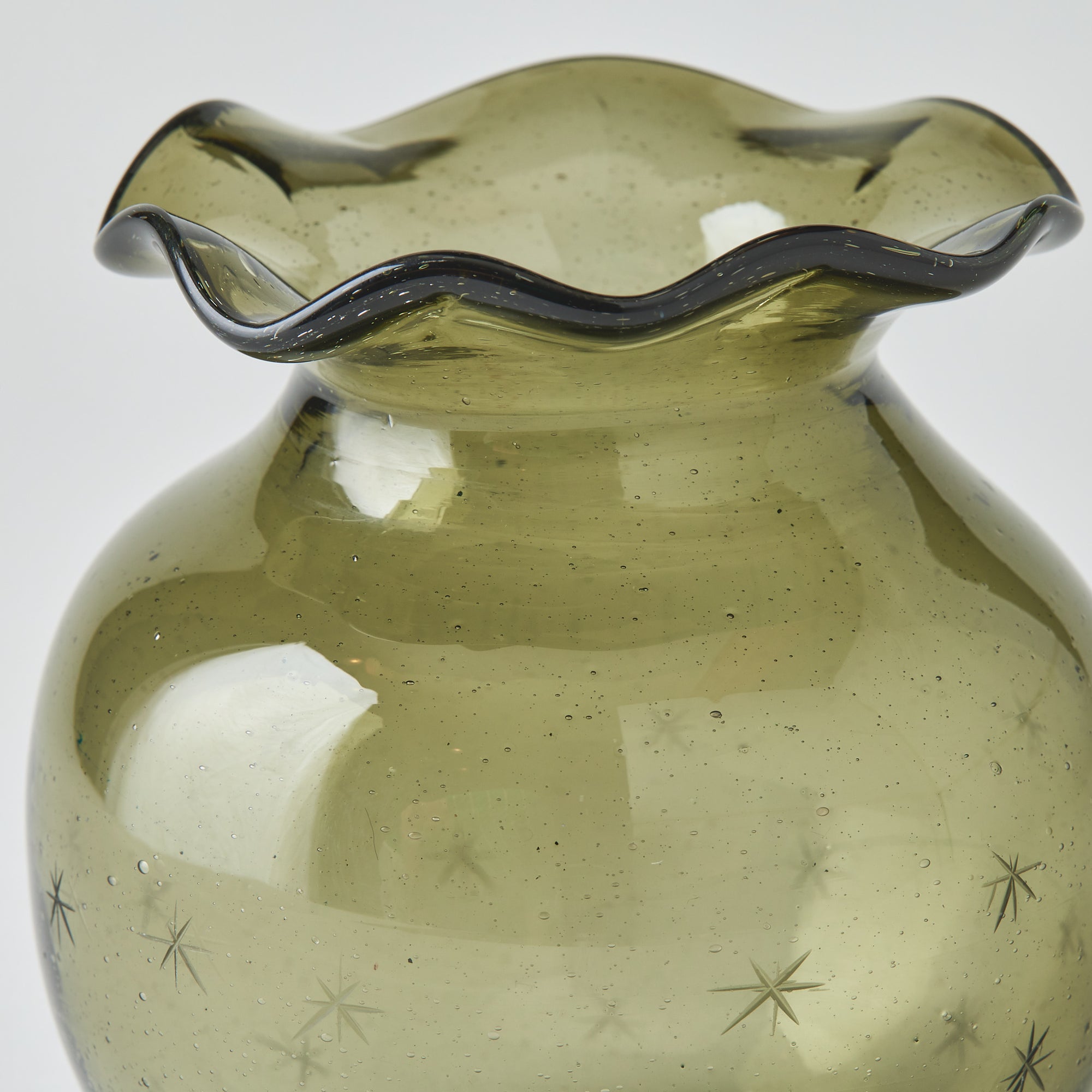 Close-up of the Starry Night pomegranate vase (smokey olive) against a neutral backdrop, focused on texture and detail.