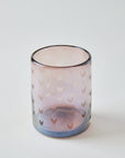 Glass candle holder with heart pattern on a white background
