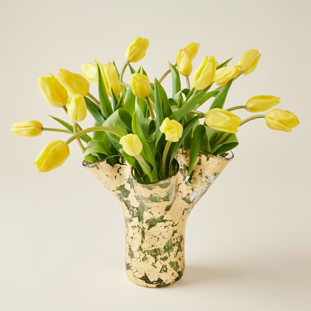 14k gold covered textured vase filled with yellow tulips