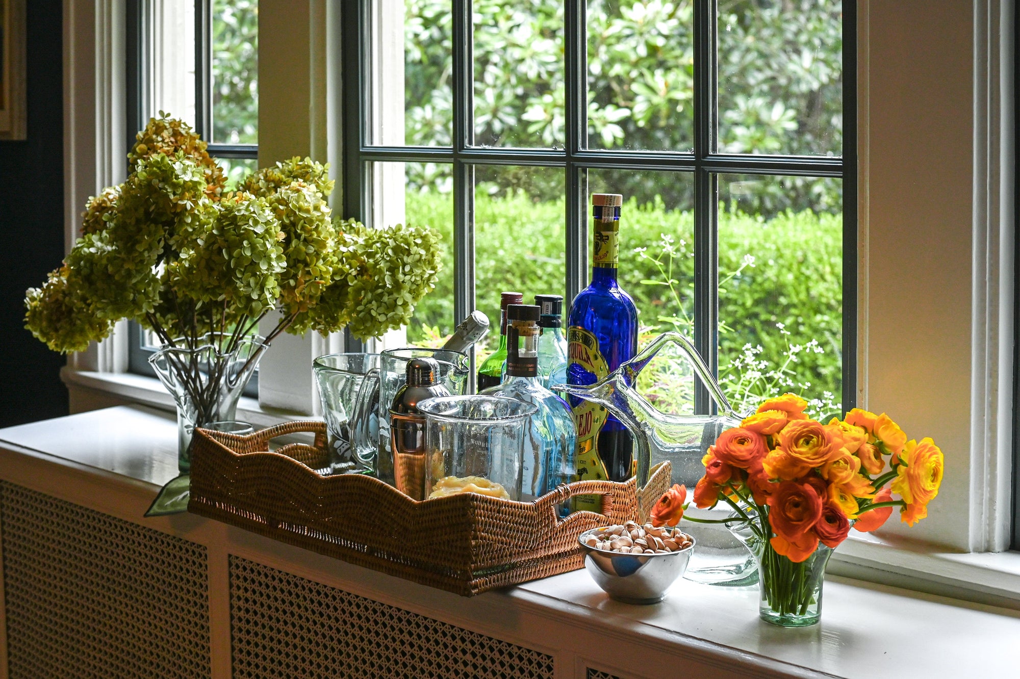 Multiple barware pieces set on a counter top behind a wall.