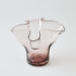 Pink glass vase with a lettuce leaf design on a white background