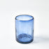Blue textured glass tumbler on a white background