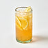 Glass of iced lemonade with lemon slices on a white background