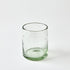 Clear glass tumbler with green tint on a white background